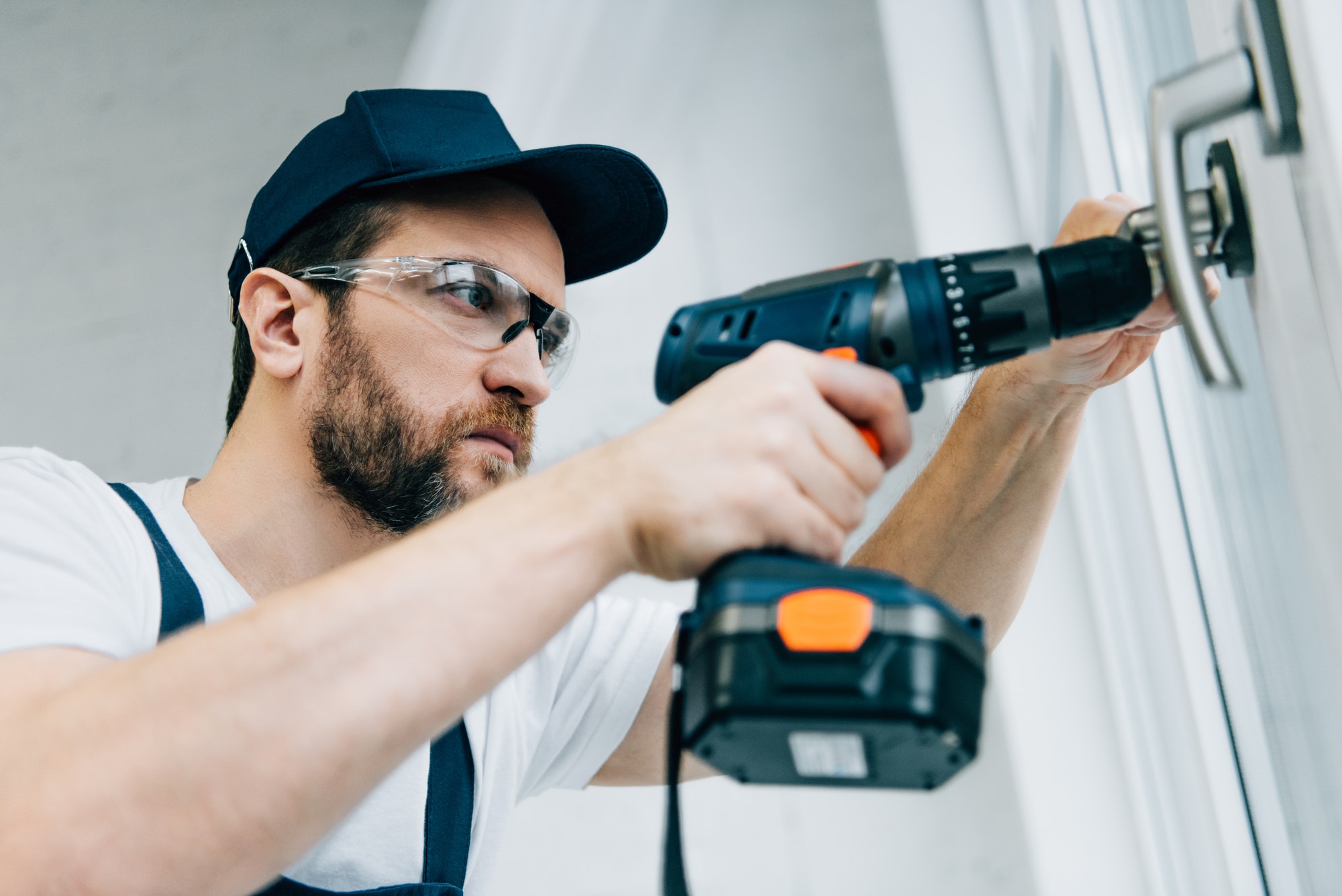 adult-repairman-in-goggles-fixing-window-handle-by-electric-drill.jpg adult-repairman-in-goggles-fixing-window-handle-by-electric-drill.jpg